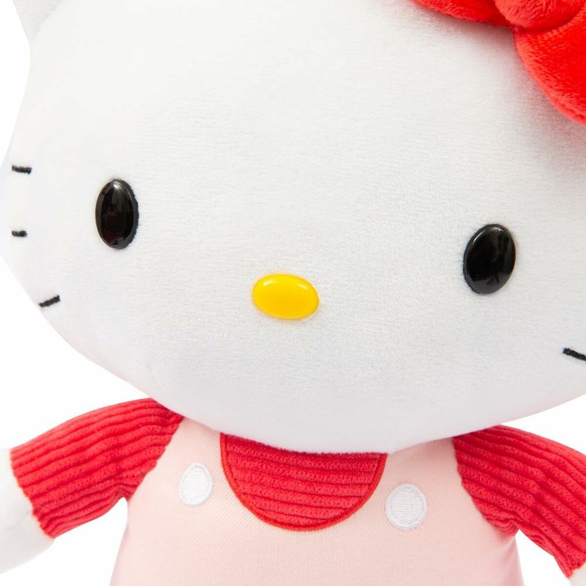 Détails du visage Peluche Hello Kitty en salopette rose